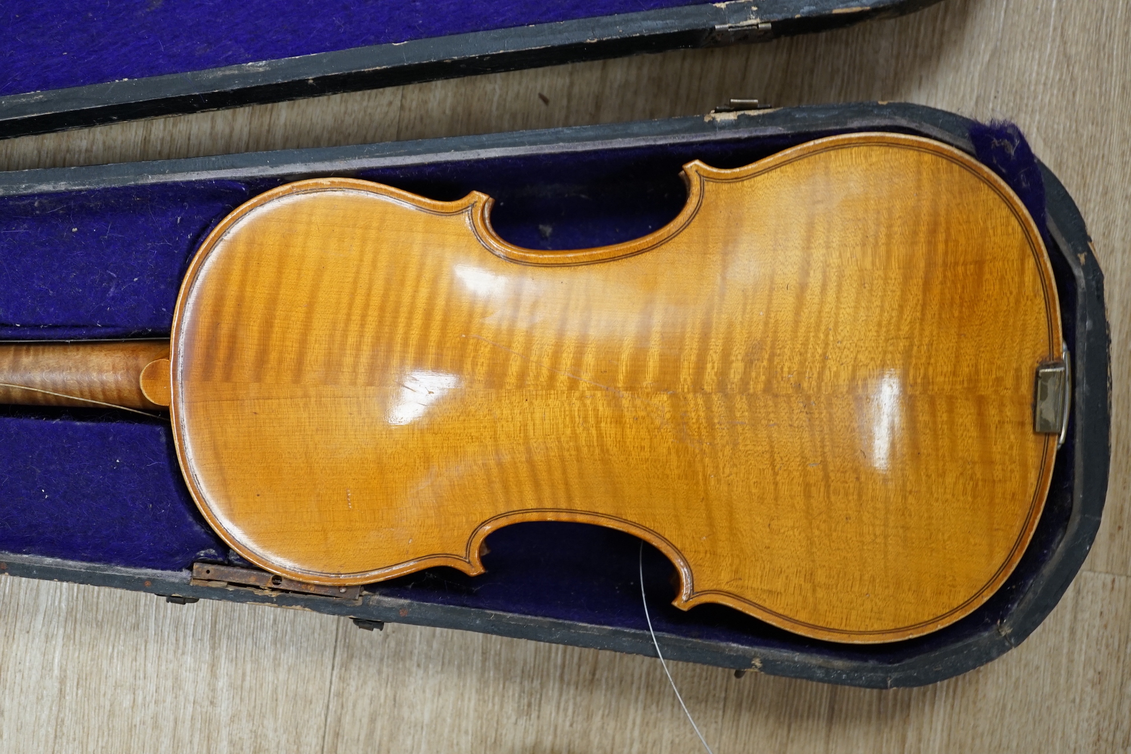 A wooden cased early 20th century Czechoslovakian student’s violin, bears ‘Copy of Stradivarius’ label, body length, 35.5cm, without bow